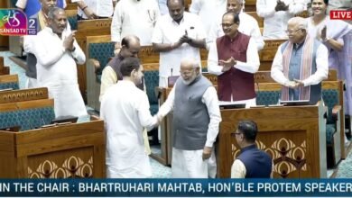 Modi and Gandhi shake hands