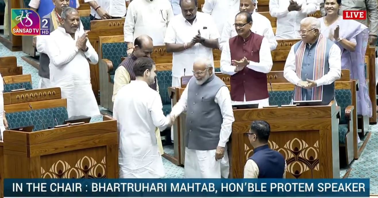 Modi and Gandhi shake hands